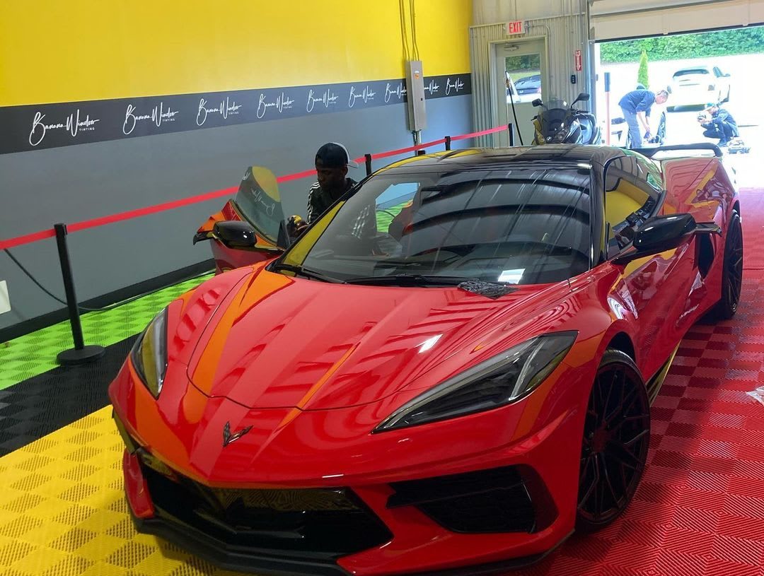 A red Corvette in the Banana Window Tinting shop
